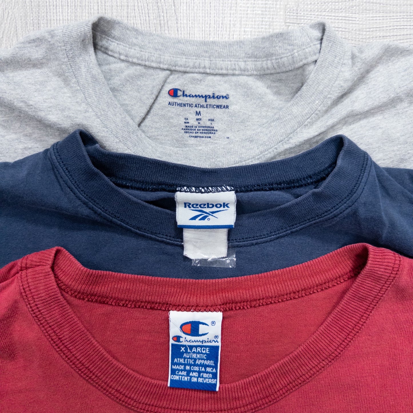 Used clothing wholesale, bulk sale, washed, mixed-brand long-sleeve T-shirts (12-pack, M-XXL) from Nike, Champion, and more.