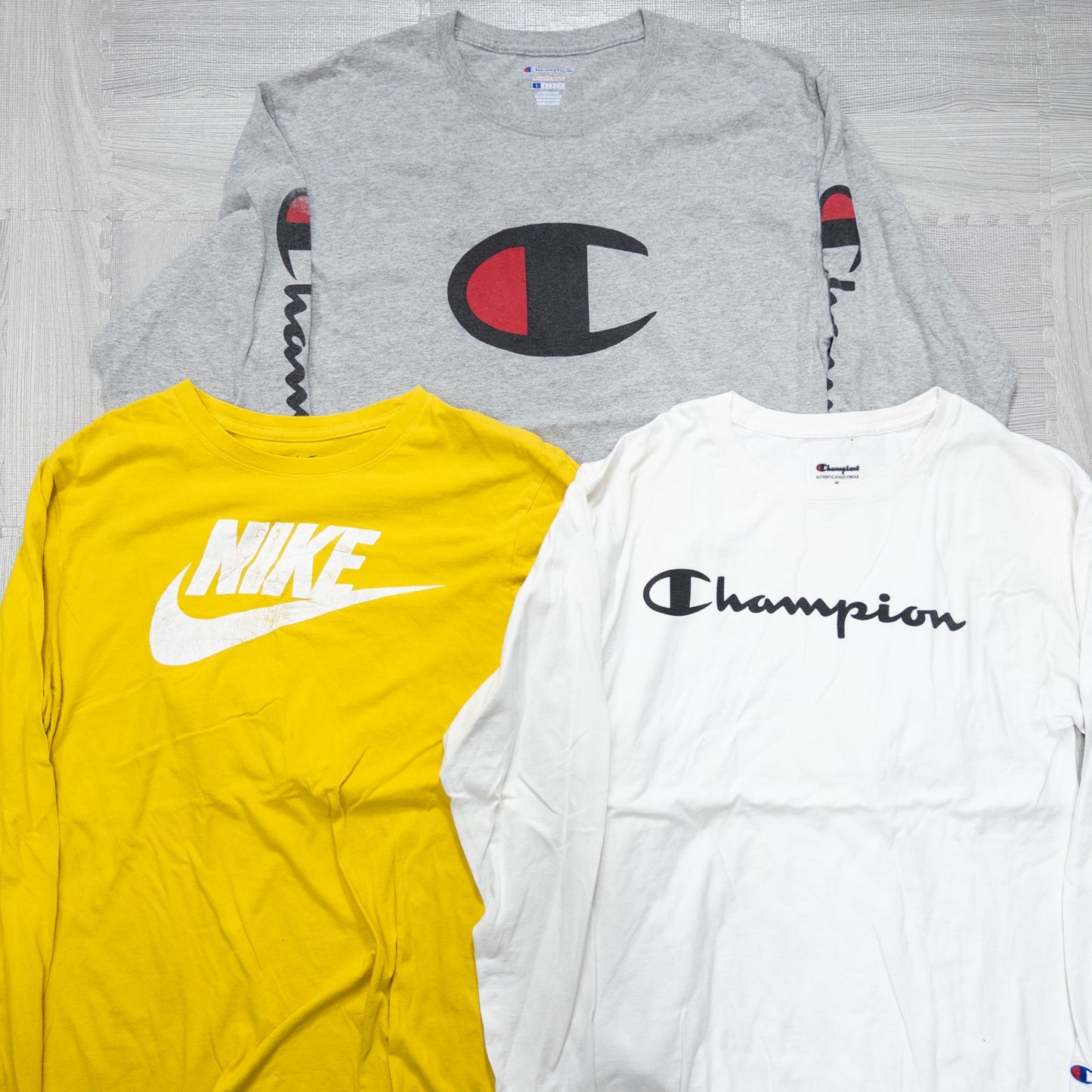 Used clothing wholesale, bulk sale, washed, mixed-brand long-sleeve T-shirts (12-pack, M-XXL) from Nike, Champion, and more.